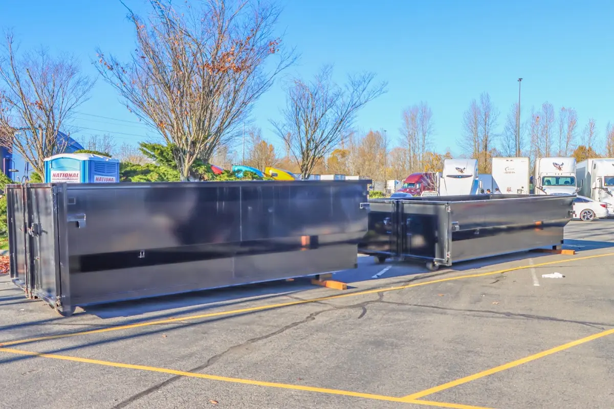 Professional dumpster rental service with roll-off container on residential driveway in Lexington